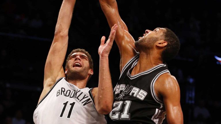 Tim Duncan of the San Antonio Spurs blocks a shot attempt from Brook Lopez of the Brooklyn Nets during an NBA game at Barclays Center on Wednesday, Dec. 3, 2014.