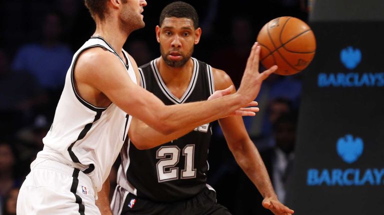 Brook Lopez of the Brooklyn Nets controls the ball against Tim Duncan of the San Antonio Spurs during an NBA game at Barclays Center on Wednesday, Dec. 3, 2014.