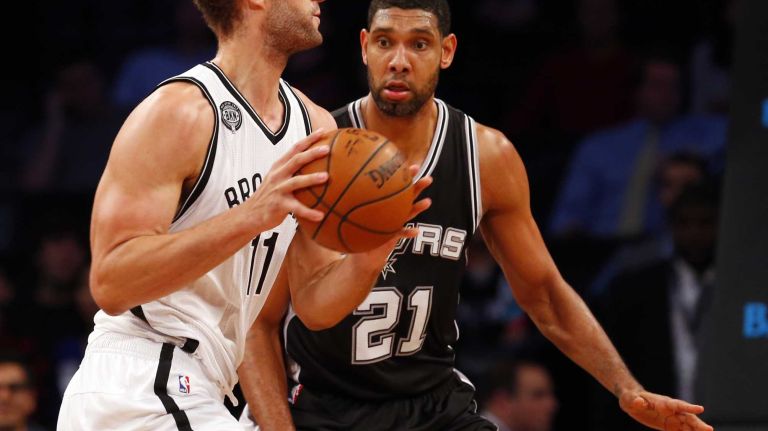 Brook Lopez of the Brooklyn Nets controls the ball against Tim Duncan of the San Antonio Spurs during an NBA game at Barclays Center on Wednesday, Dec. 3, 2014.