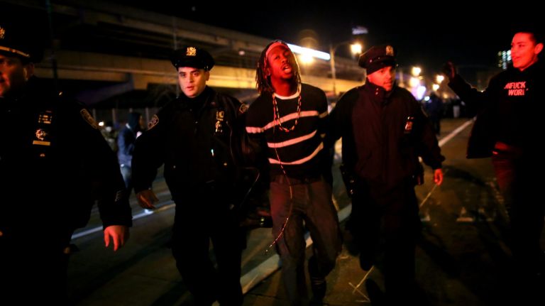 Police detain a protester on the West Side Highway on December 3, 2014.