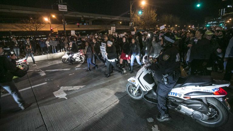 Protesters march on the West Side Highway after a grand jury decided not to indict NYPD Officer Daniel Pantaleo Wednesday, Dec. 4, 2014.
