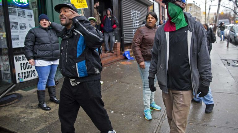 People react in anger Wednesday, Dec. 3, 2014, near the spot where Eric Garner died in July while he was being put into police custody. A grand jury on Wednesday decide not indict NYPD Officer Daniel Pantaleo for his role in the case.