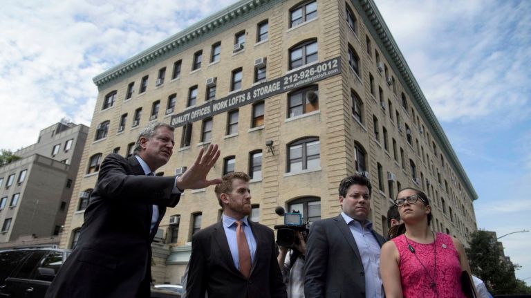 Mayor Bill de Blasio has demanded more information about immigrant children separated from their parents and brought to New York. Above, he walks by a center on Wednesday where at least 300 children have been processed since April.
