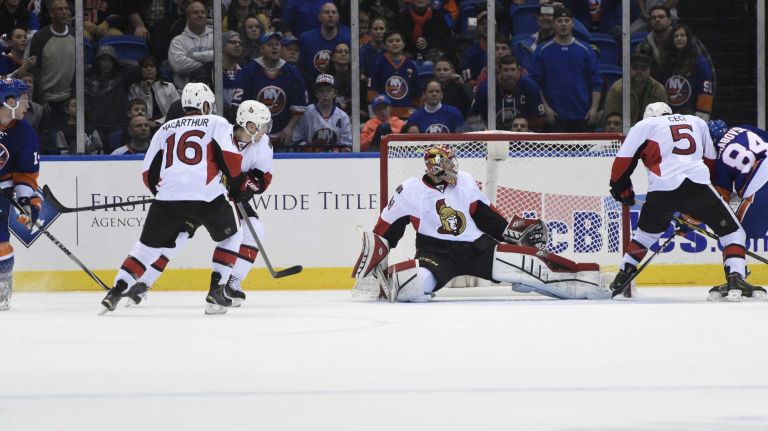 Islanders vs. Senators 31 New York Islanders defenseman Thomas Hickey, left, watches his shot that hit of the skate of Ottawa Senators defenseman Cody Ceci to score a goal in overtime in an NHL game at Nassau Coliseum on Tuesday, Dec. 2, 2014.