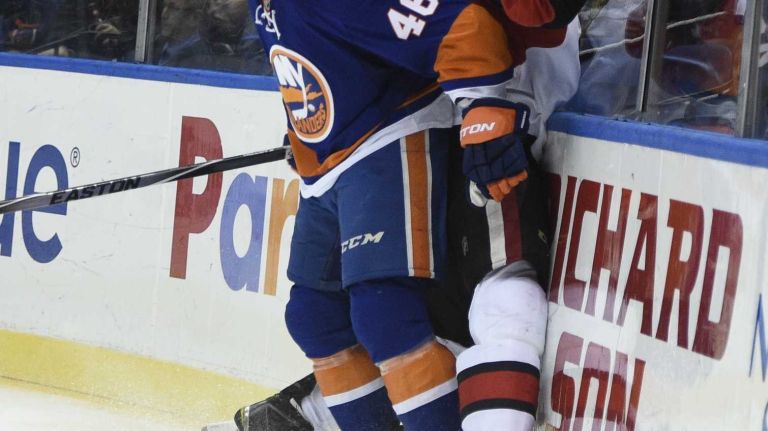 Islanders vs. Senators 33 New York Islanders defenseman Matt Donovan checks Ottawa Senators defenseman Jared Cowen up against the boards in the second period of an NHL game at Nassau Coliseum on Tuesday, Dec. 2, 2014.