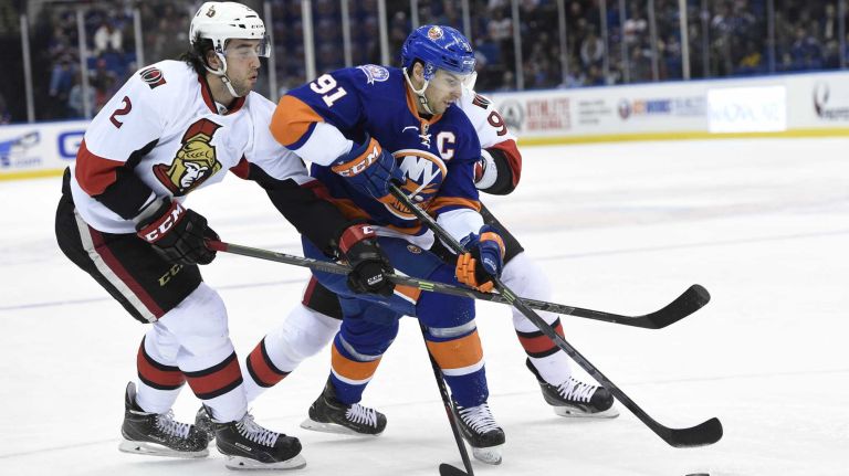 Islanders vs. Senators 40 New York Islanders center John Tavares battles for the puck with Ottawa Senators defenseman Jared Cowen and left wing Milan Michalek in the first period of an NHL game at Nassau Coliseum on Tuesday, Dec. 2, 2014.