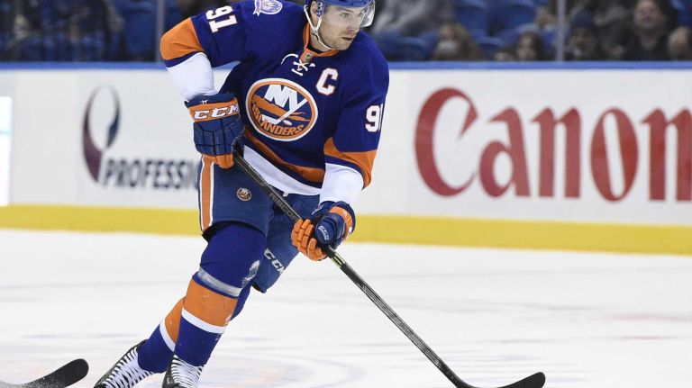 Islanders vs. Senators 42 New York Islanders center John Tavares skates with the puck against the Ottawa Senators in the first period of an NHL game at Nassau Coliseum on Tuesday, Dec. 2, 2014.