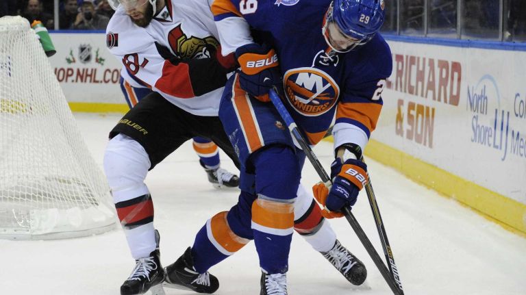 Islanders vs. Senators 49 New York Islanders center Brock Nelson and Ottawa Senators defenseman Eric Gryba battle for the puck in the first period of an NHL game at Nassau Coliseum on Tuesday, Dec. 2, 2014.