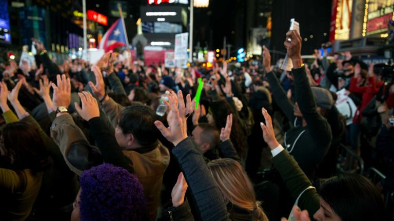 Protesters stand in silence as they gather in Times Square on Tuesday, Nov. 25, 2014, a day after a grand jury decision was announced in Ferguson, Missouri, showing no cause for indictment of Officer Darren Wilson, who shot and killed an unarmed Michael Brown in August. There were arrests in Times Square earlier in the march.