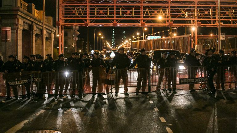 NYPD officers enforce a barrier as protesters gather in Lower Manhattan on Tuesday, Nov. 25, 2014, in response to the grand jury decision regarding the fatal shooting of Michael Brown in Ferguson, Mo.