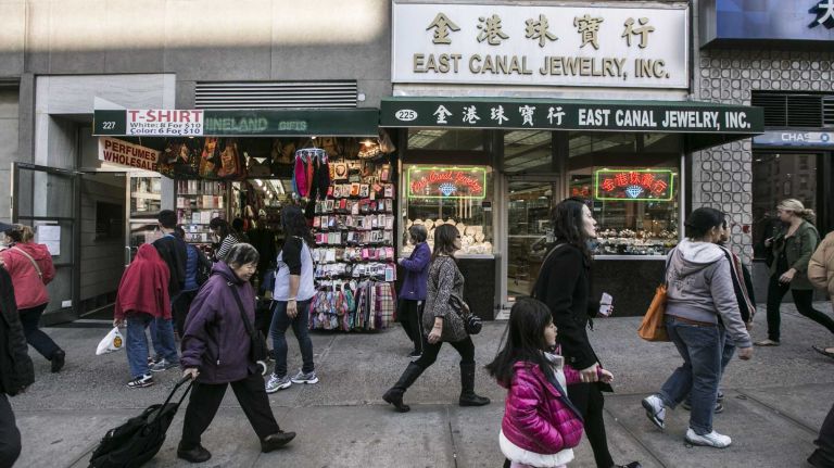 People walk along Canal Street in Chinatown in Manhattan, on Nov. 4, 2014.