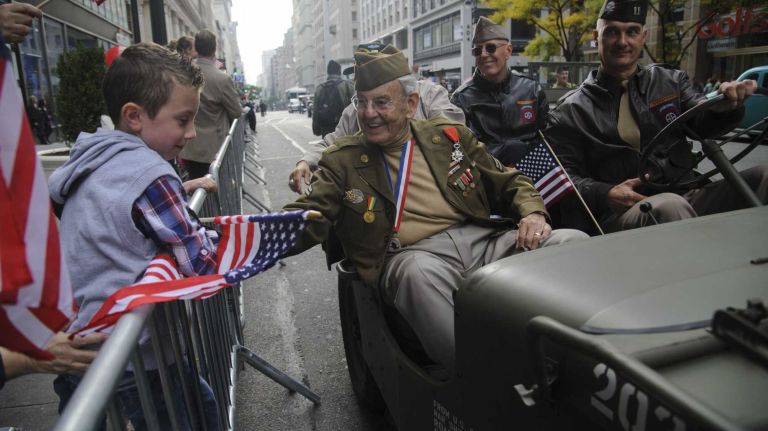 NYC Veterans Day Parade in images 20 World War II veteran Arnold Franco reaches out to Nico Davis, 6, of Port Jefferson, during the 95th annual New York City Veterans Day Parade on Tuesday, November 11, 2014.