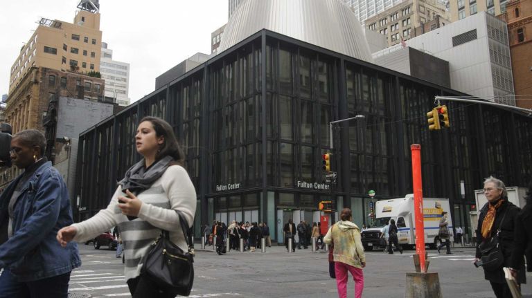 Fulton Center photos 34 Pedestrians walk past the newly constructed Fulton Street Transit Center in lower Manhattan on Nov. 5, 2014. The MTA says that the new transit hub will provide seamless transfer for approximately 300,000 passengers.