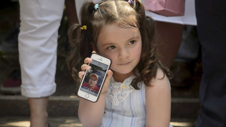 Family of detained deliveryman Pablo Villavicencio rally for his release from ICE detention 3 Sandra Chica's daughter Luciana, 3, holds a cell phone with a photo of her father, Pablo Villavicencio, on Monday.
