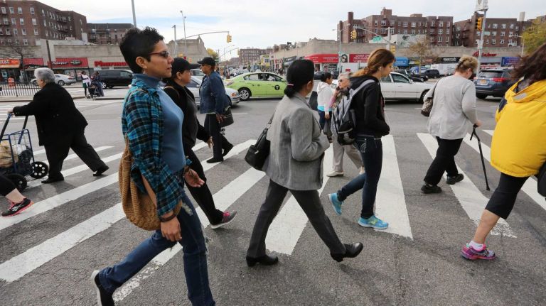 People cross 63rd. Rd. at Queens Blvd. in Rego Park