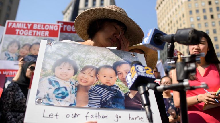 Yu Mei Chen, center, the wife of detained immigrant Xiu Qing You, gets emotional as advocates, community leaders and elected officials rally at Foley Square on Monday.