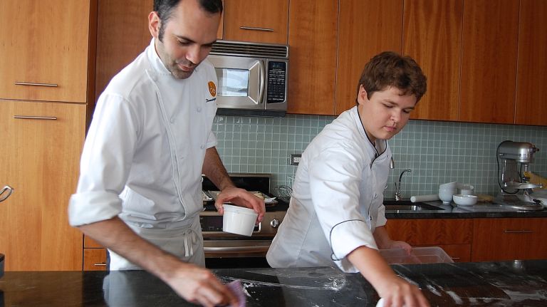 Dominque Ansel and MasterChef Junior winner Alexander Weiss show that cleaning is an important part of cooking. 