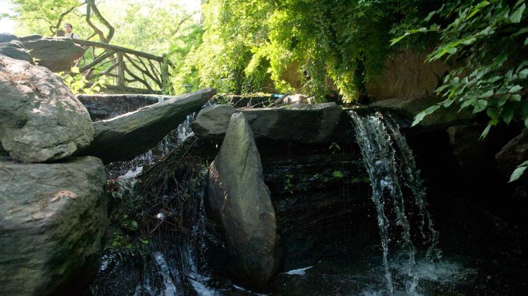 A waterfall cascades over rocks that lead to the Glen Span Arch in Central Park. (May 29, 2012)
