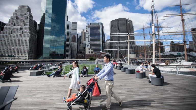 People walk on the East Side Esplanade