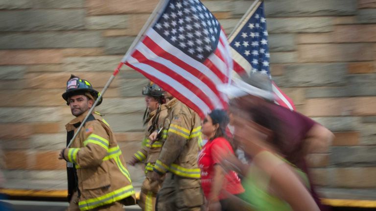 Runners exit the Hugh L. Carey Tunnel on Sunday, Sept. 28, 2014, as part of the 13th Annual Stephen Siller Tunnel to Towers Run that honors fallen 9/11 heroes.