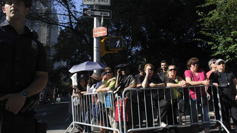 Fans of Joan Rivers stand across the street from Temple Emanu-El before a private funeral for the comedian in Manhattan on Sunday, Sept. 7, 2014. Rivers died Sept. 4 at 81, days after going into cardiac arrest during an outpatient procedure.
