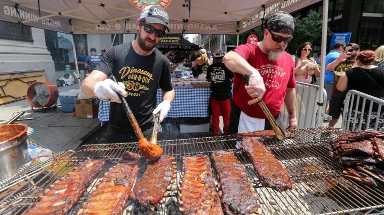 Grill masters Jake Timmons, left, and Scott Irvine from Dinosaur Bar-B-Que served up their best at the Big Apple Barbecue Block Party in Madison Square Park on Saturday.