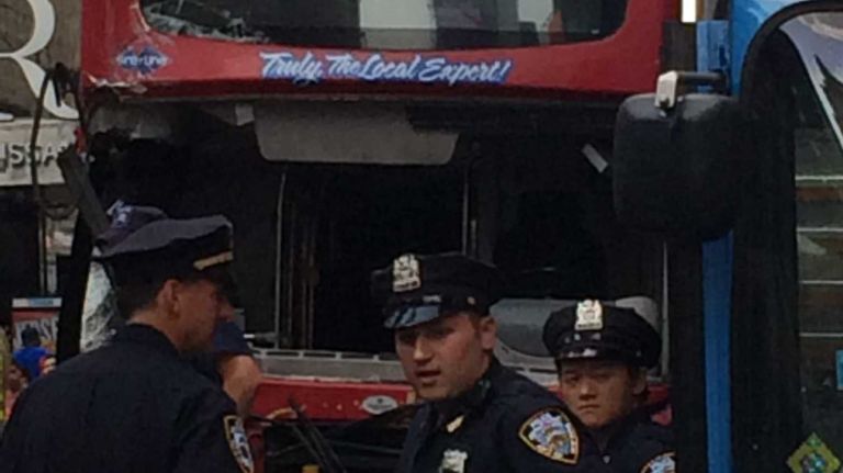 Police at the scene where two double-decker tour buses collided near Times Square, at West 47th Street and Seventh Avenue, on Tuesday, Aug. 5, 2014. At least 14 people were injured, according to the FDNY and NYPD. 