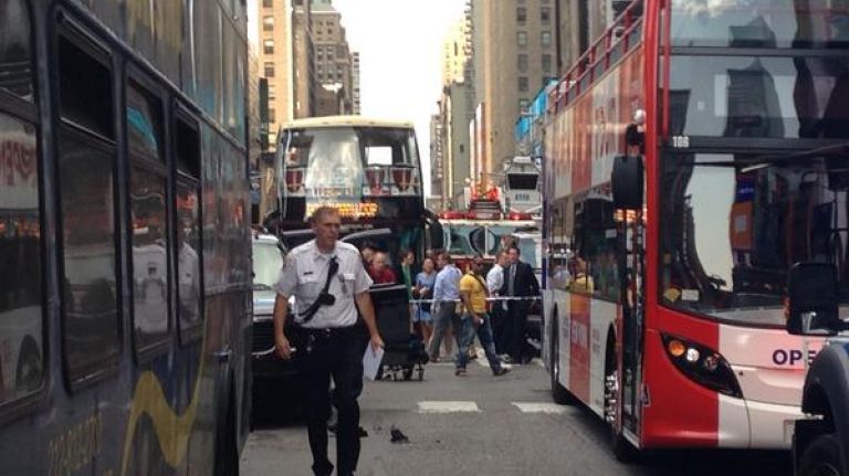 The scene after two double-decker tour buses collided near Times Square, at West 47th Street and Seventh Avenue, on Tuesday, Aug. 5, 2014.