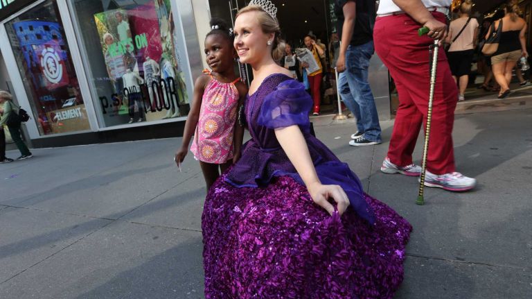 Sophie Richards, promoting the show, Cinderella, poses with Kairah Bellamy, 3, in Times Square, on Tuesday, July 22 2014. 