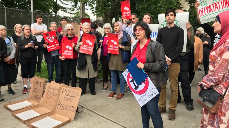 People protest outside Fort Hamilton in Brooklyn after soldiers called immigration agents on pizza deliveryman Pablo Villavicencio, who was then detained.