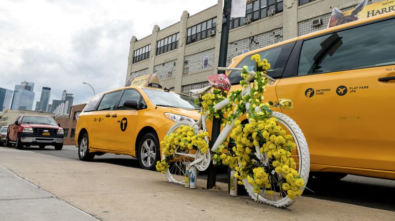 A so-called ghost bike, decorated in flowers, memorializes Queens resident Gelacio Reyes, who was fatally struck by a car while riding his bike in April 2017.