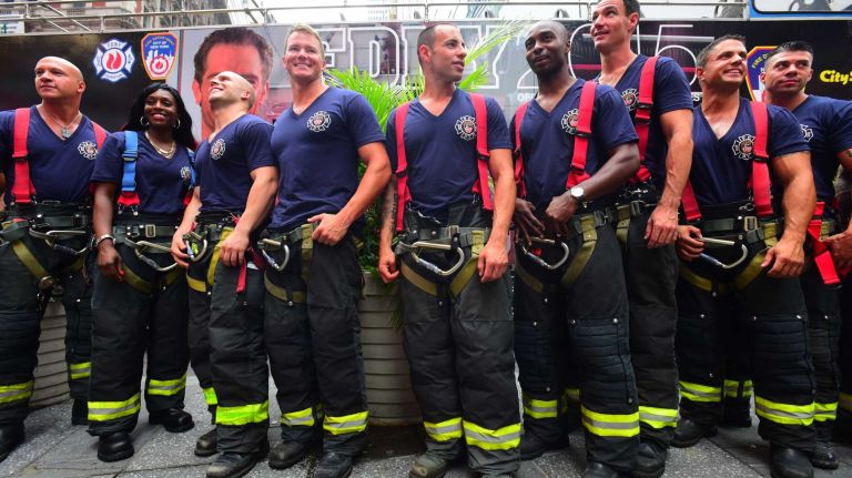 The FDNY's 2015 Calendar of Heroes models strike a post in Times Square on July 15, 2014.