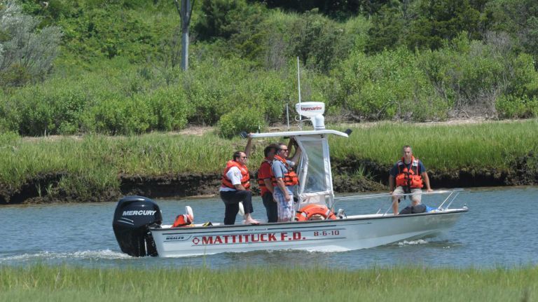 Mattituck fire and rescue personnel on the scene at Mattituck Inlet, south of where a small airplane crashed in the Long Island Sound on Monday, July 7, 2014.
