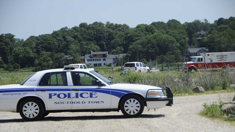 Southold Town police and Mattituck fire and rescue personnel respond to Mattituck Inlet on Monday, July, 7, 2014, near where a small airplane crashed in the Long Island Sound. 