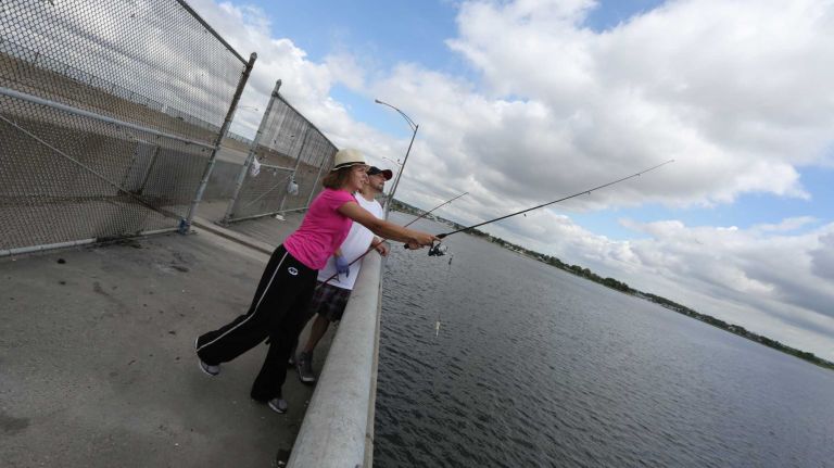 Alicia Gonzalez, and dad, Allan, fish off the Joseph P. Addabbo Memorial Bridge, which separates Howard Beach from Broad Channel, in Howard Beach, Queens, Thursday, June 26, 2014.