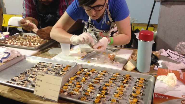 Lilith Spencer from BKLYN Larder in Park Slope prepares her perfect bite of Midnight Moon goat Gouda with candied kumquat, toasted sesame seed-cocoa nibs and orange blossom water.