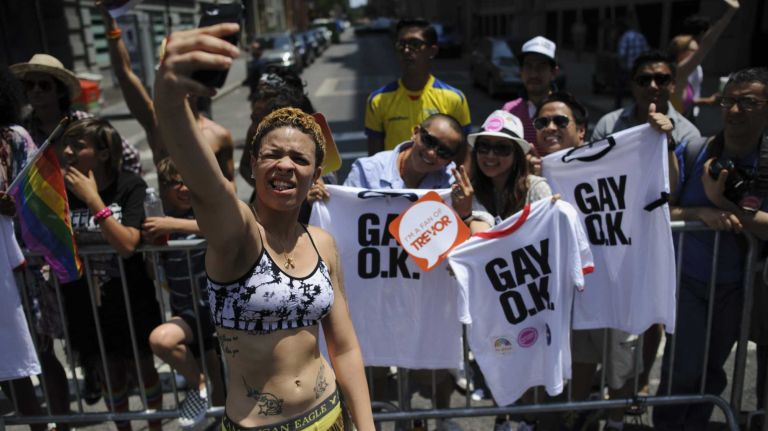 A participant takes a selfie during the New York City pride parade in Manhattan on Sunday, June 29, 2014.