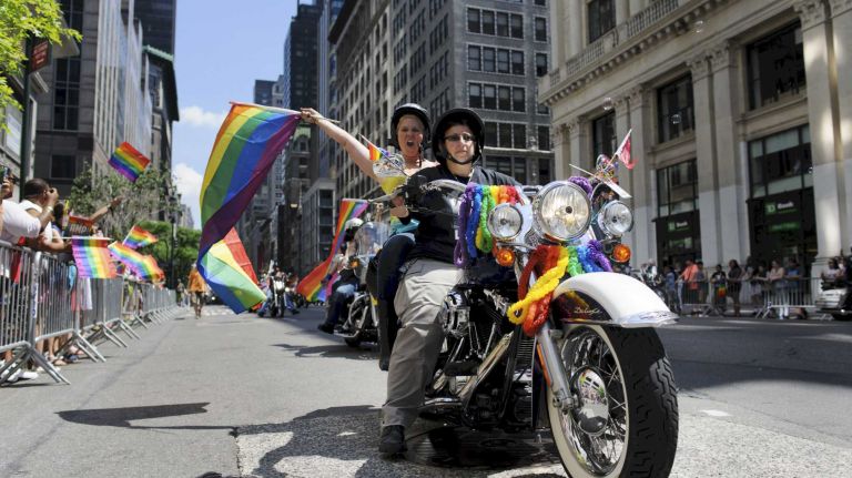 Members of the Sirens women's motorcycle club ride toward the start of New York City's gay-pride parade on Sunday, June 29, 2014, in Manhattan. The parade this year marks 45 years since the raid on the Stonewall Inn, and the riots that followed, starting America's gay-rights movement.
