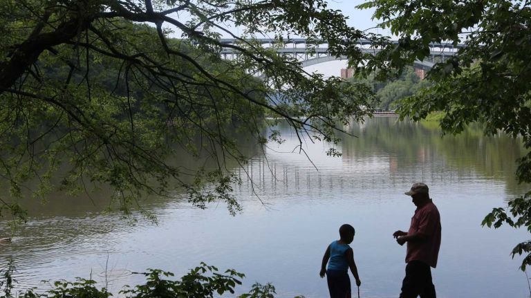 Roberto Garcia and son, Andrew at the waterfront at Inwood Hill Park in Inwood, Thursday, June 19, 2014. 