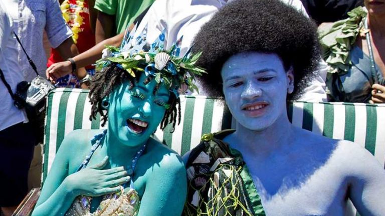 Chiara de Blasio and Dante de Blasio, posing as King Neptune and Queen Mermaid, react as their parents, Chirlane McCray and New York City Mayor Bill de Blasio, kiss as they march in the annual Coney Island Mermaid Parade on Saturday, June 21, 2014.