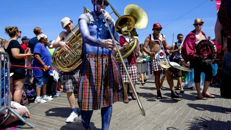 Participants move along during the annual Coney Island Mermaid Parade on Saturday, June 21, 2014.