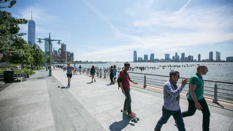 People walk in Hudson River Park in Hudson Square in Manhattan on June, 1, 2014. 