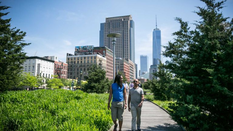 People walk in Hudson River Park in Hudson Square in Manhattan on June, 1, 2014. 