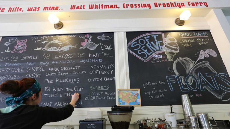 Charlotte Mizrahi adds the new flavors to the board at Ample Hills Creamery in Prospect Heights, Brooklyn, Wednesday, May 7, 2014. Ample Hills makes their ice cream in house and will be opening a new store in Gowanus in June.