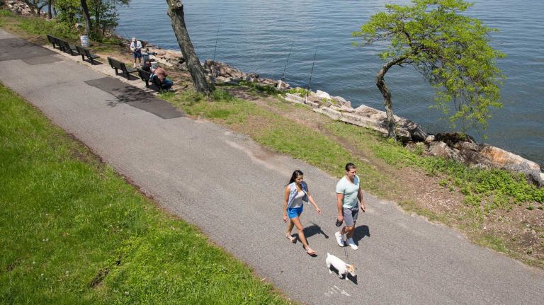 A couple walks along Little Neck Bay in North Bayside on Saturday, May 17, 2014.