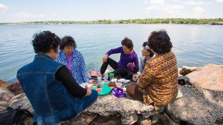 A group of woman sit by the water of Little Neck Bay in North Bayside on Saturday, May 17, 2014.