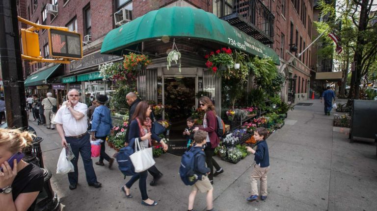 People walk at the intersection of Lexington and East 78th Street.