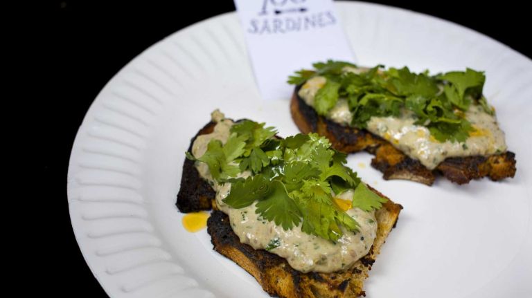 Sardines: the cool new fish swimming onto NYC menus 4 Aldea chef George Mendes has always been a fan of sardines, which are hugely popular in his family's native Portugal. And at his Mad Sq. Eats pop-up, he even imports them from the homeland. The sardine toast features a mixture of fresh and tinned sardines with garlic mayo and yogurt, diced cucumbers, parsley, cilantro and lemon atop broa, a rye cornbread made at Aldea. It's Portuguese perfection. $8; Mad Sq. Eats, running now through May 30 at Worth Square, W. 25th Street and Broadway, Urbanspacenyc.com/mad-sq-eats