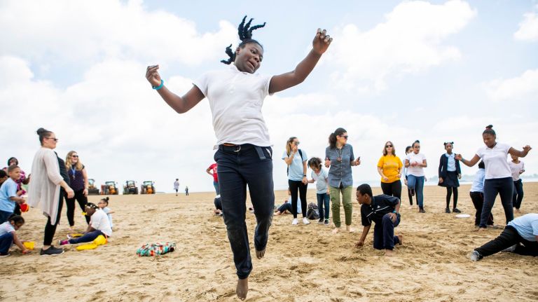 Tyra Figueroa, 10, dances at the ceremonial opening of Orchard Beach in the Bronx