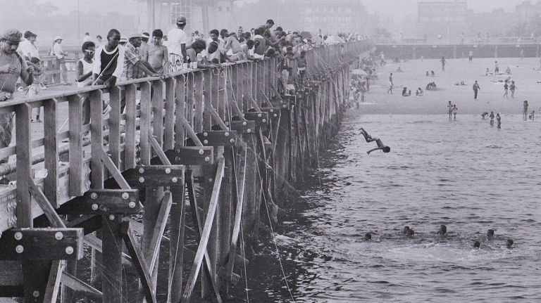Kids dive off the pier 40 feet above the water in Coney Island. (July 25, 1987)